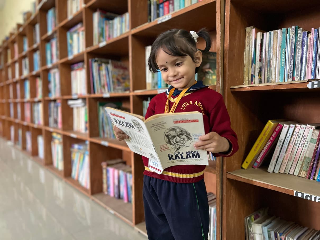 A young student reading in the school library